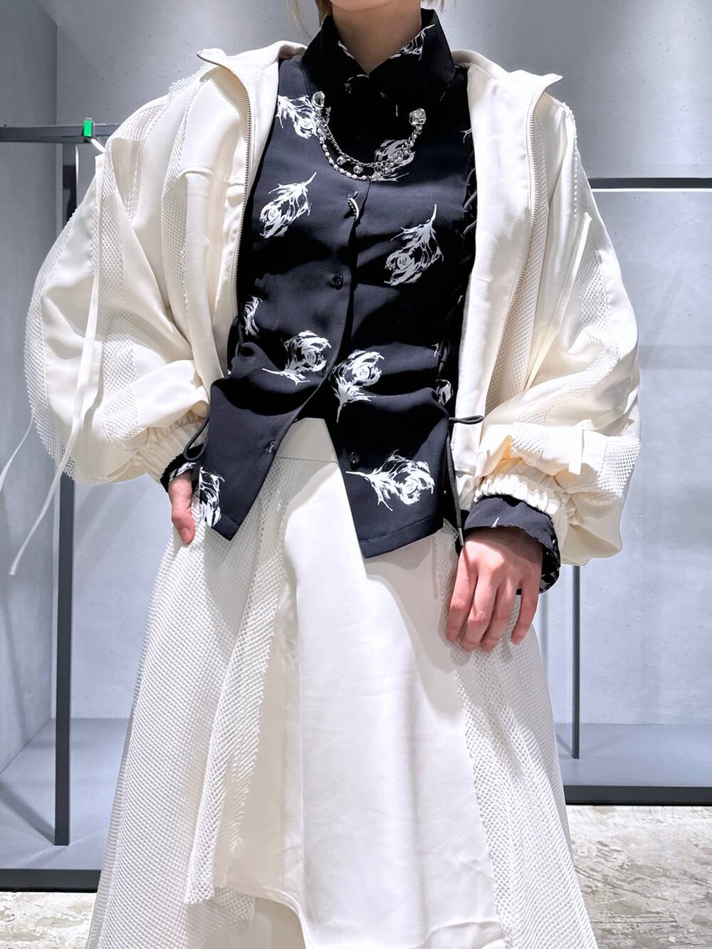 ブラック系のスニーカー、ホワイト系のブルゾン、ホワイト系のスカートを着用したレディースの冬コーディネートの4枚目の写真