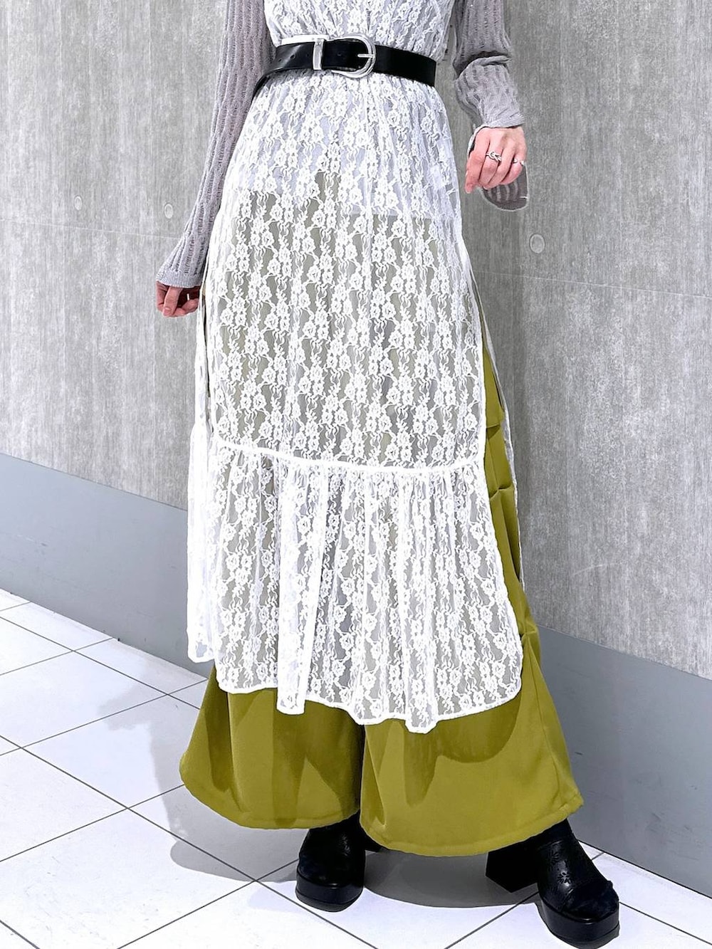 イエロー系のカーゴパンツ、グレー系のニット/セーター、ホワイト系のワンピースを着用したレディースの春コーディネートの8枚目の写真