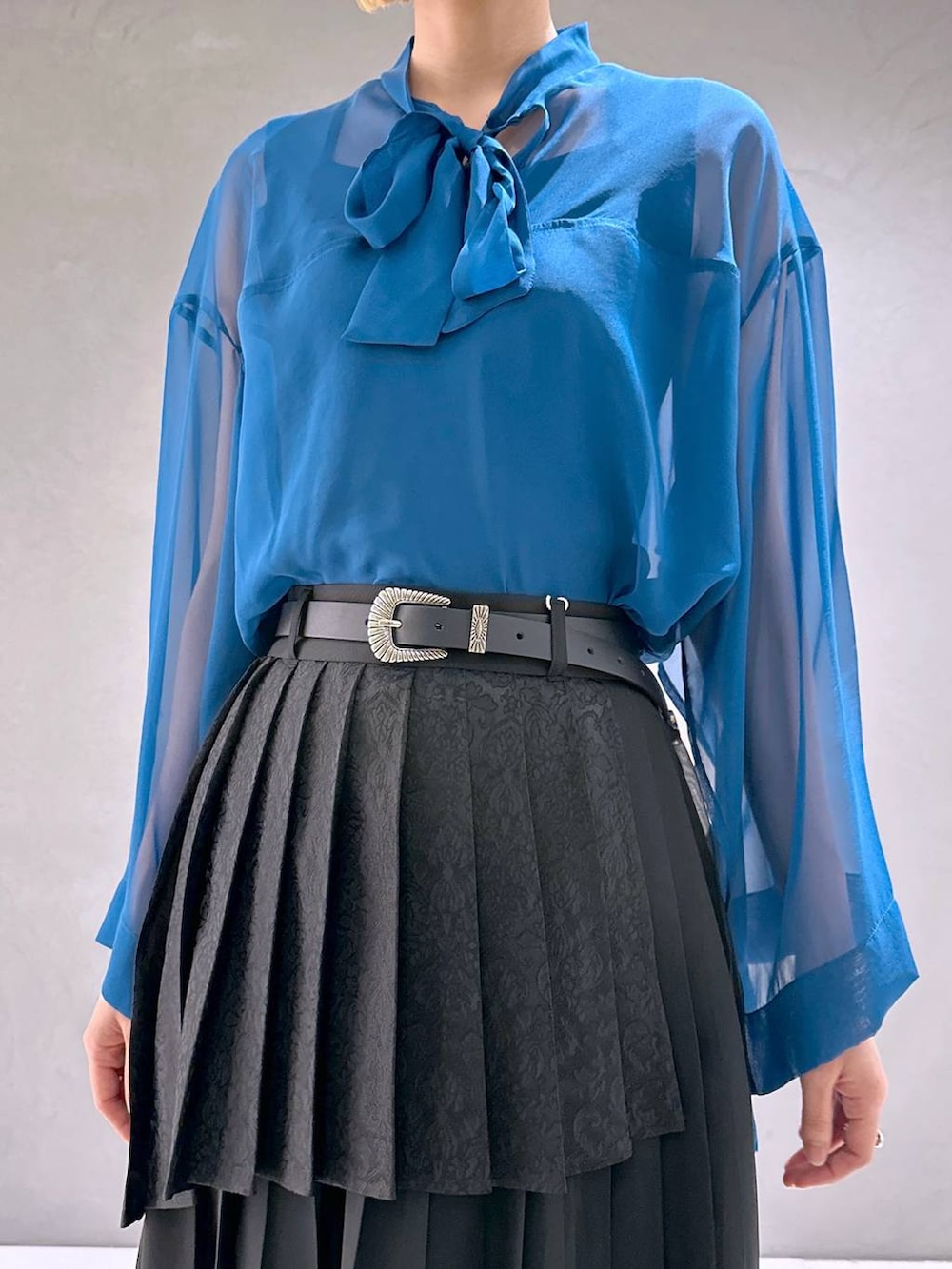 ブラック系のサンダル、ブラック系のスカート、ブルー系のTシャツ/カットソーを着用したレディースの春コーディネートの5枚目の写真