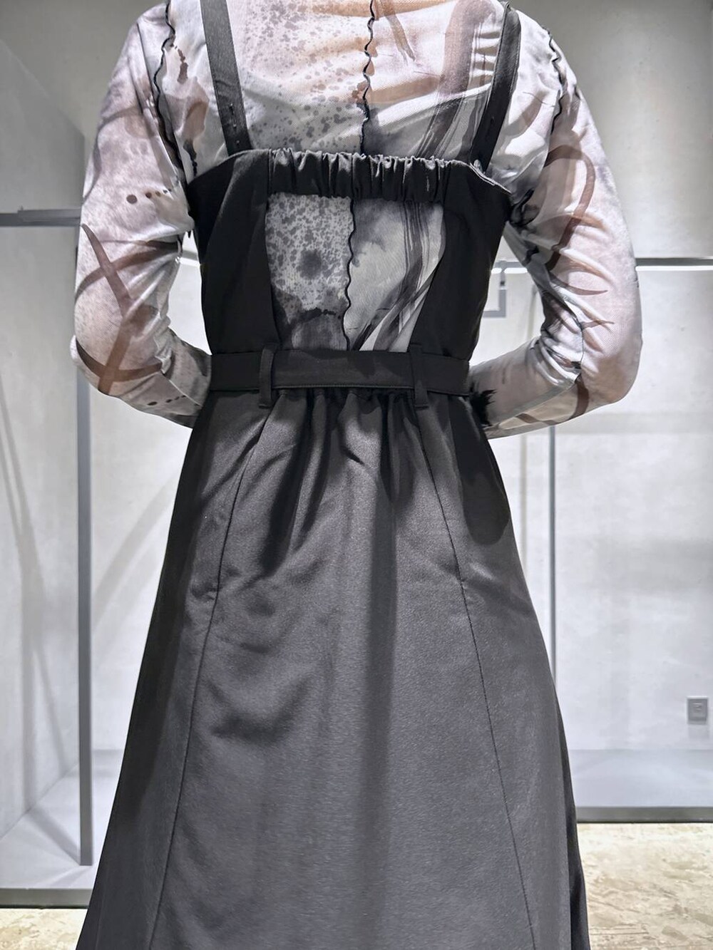 ブラック系のサンダル、ブラック系のジャンパースカート、ホワイト系のTシャツ/カットソーを着用したレディースの夏コーディネートの4枚目の写真