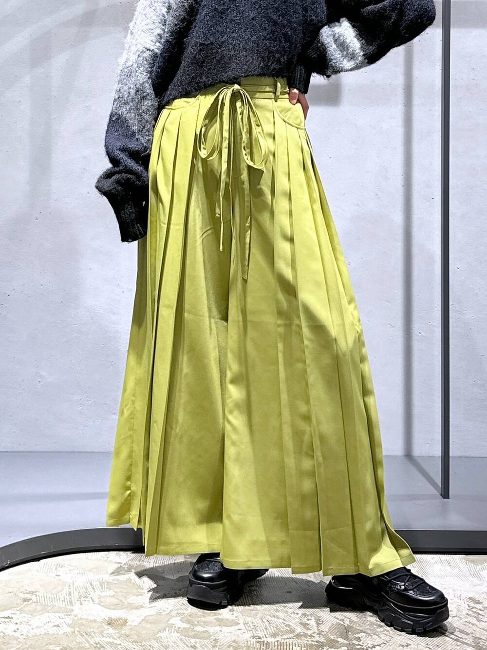 ブラック系のニット/セーター、グリーン系のその他パンツ、ブラック系のスニーカーを着用したレディースの冬コーディネートの6枚目の写真