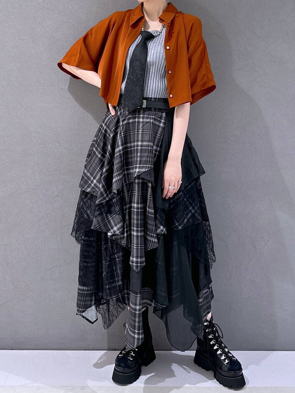 ブラック系のネクタイ、ブラック系のサンダル、グレー系のタンクトップを着用したレディースの春コーディネートの4枚目の写真