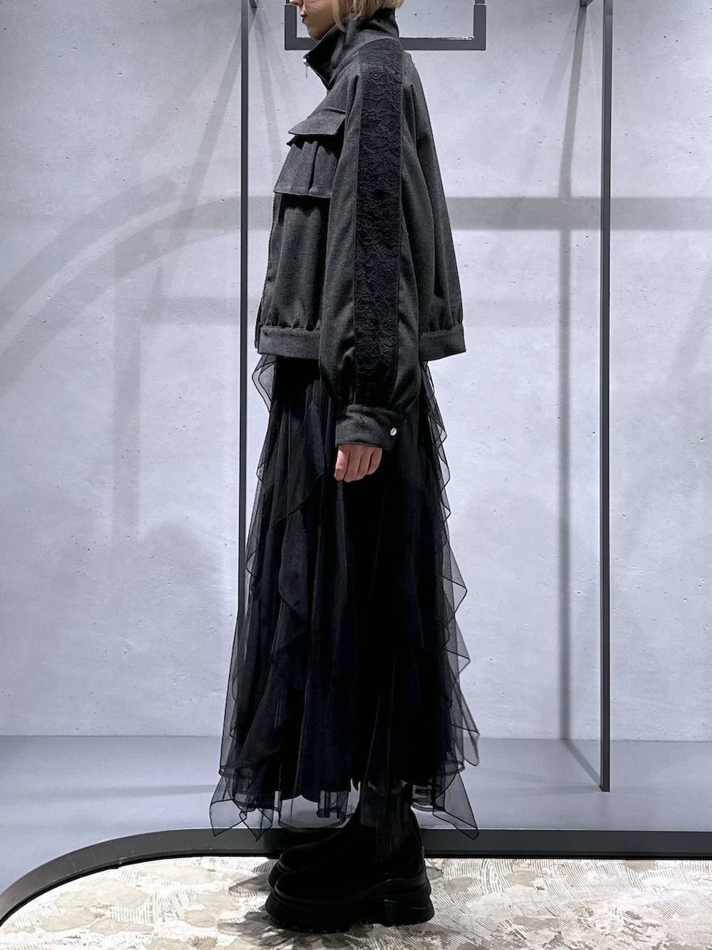 ブラック系のブーツ、イエロー系のカーディガン/ボレロ、グレー系のブルゾンを着用したレディースの冬コーディネートの2枚目の写真