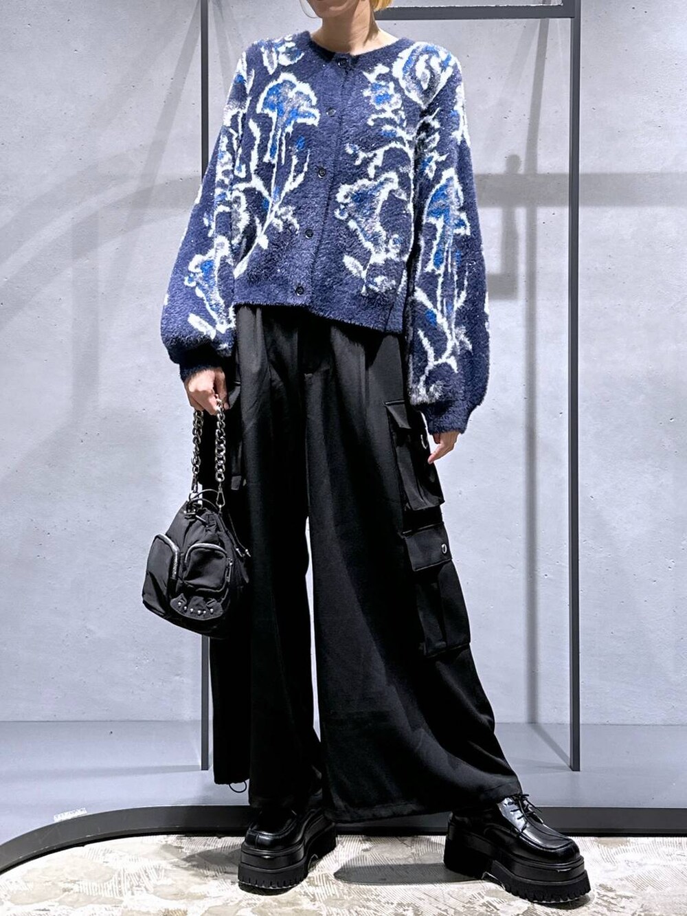 パープル系のカーディガン/ボレロ、ブラック系のショルダーバッグ、ブラック系のカーゴパンツを着用したレディースの秋コーディネートの4枚目の写真