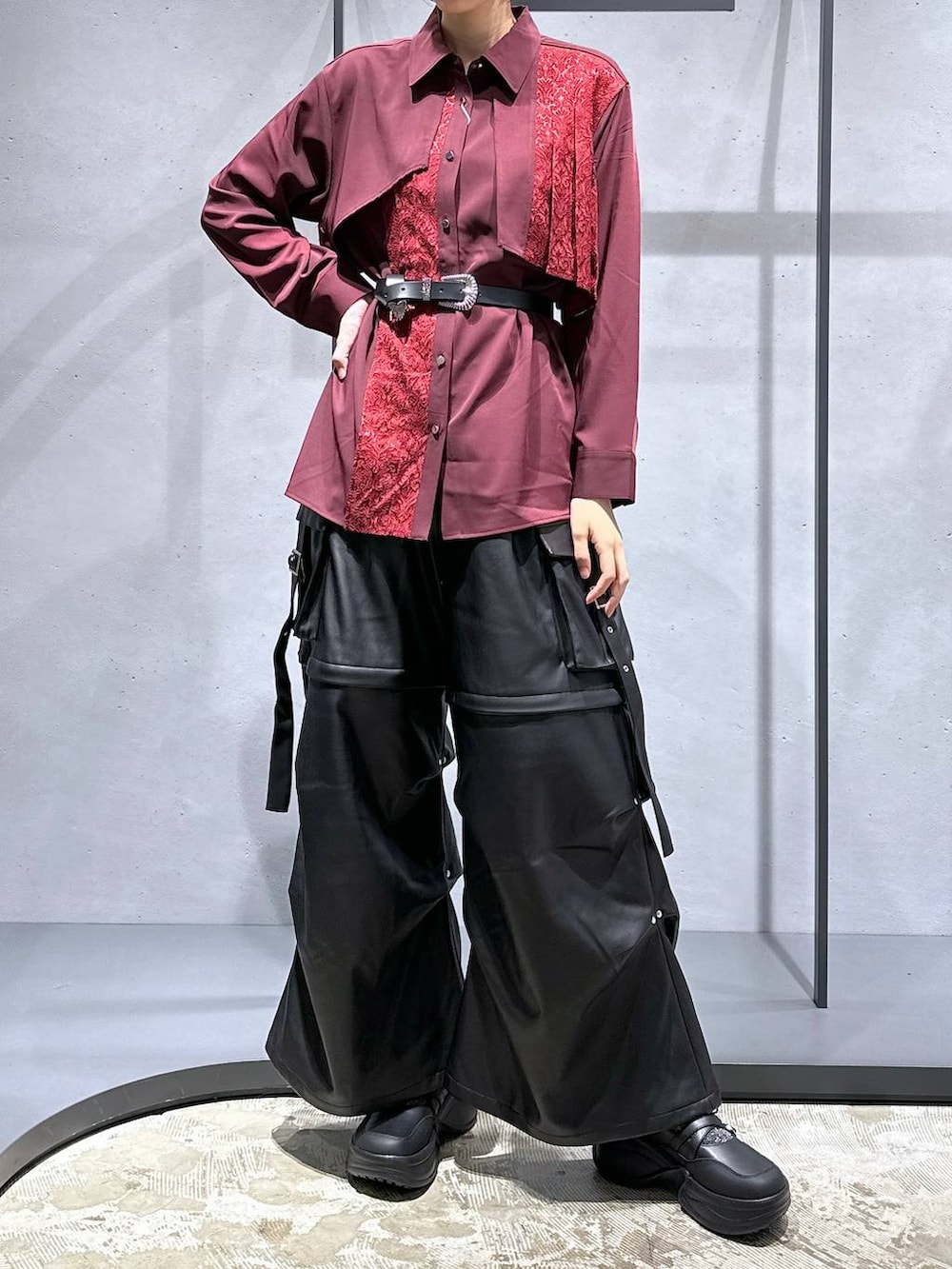 ブラック系のカーゴパンツ、ブラック系のブーツ、レッド系のシャツ/ブラウスを着用したレディースの夏コーディネートの4枚目の写真