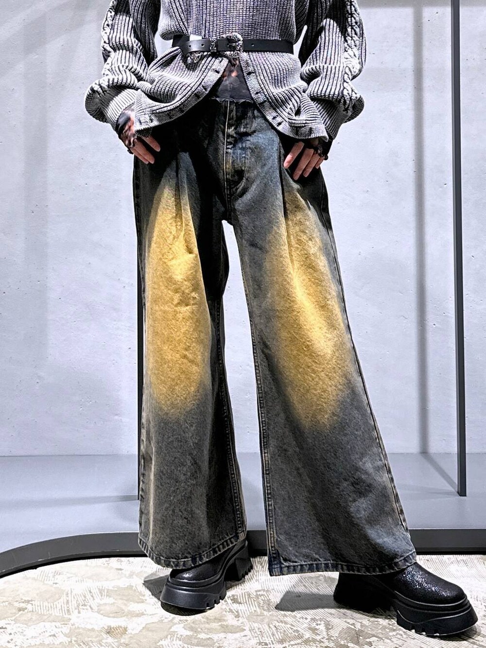 オレンジ系のデニムパンツ、ブラック系のブーツ、オレンジ系のTシャツ/カットソーを着用したレディースの秋コーディネートの6枚目の写真