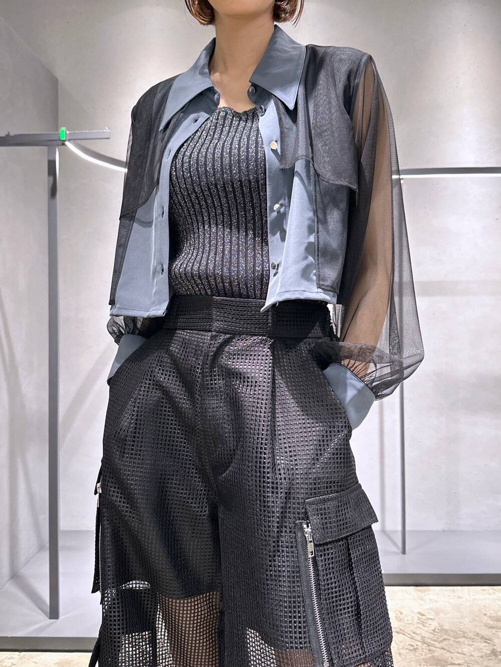 ブラック系のタンクトップ、ブラック系のサンダル、ブラック系のカーゴパンツを着用したレディースの夏コーディネートの5枚目の写真