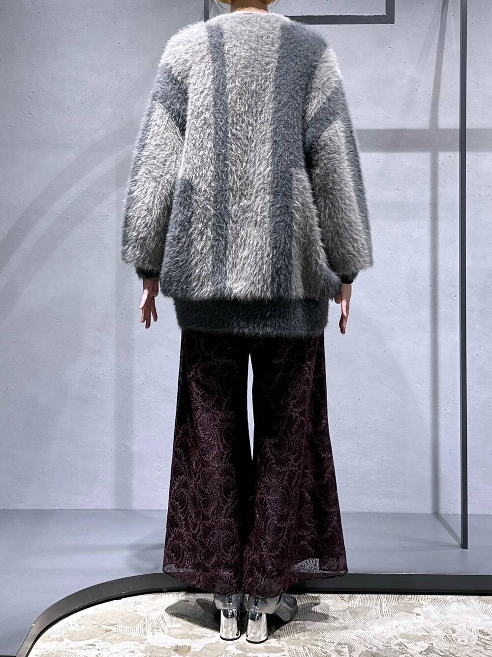 グレー系のカーディガン/ボレロ、シルバー系のブーツ、ブラック系のニット/セーターを着用したレディースの秋コーディネートの3枚目の写真