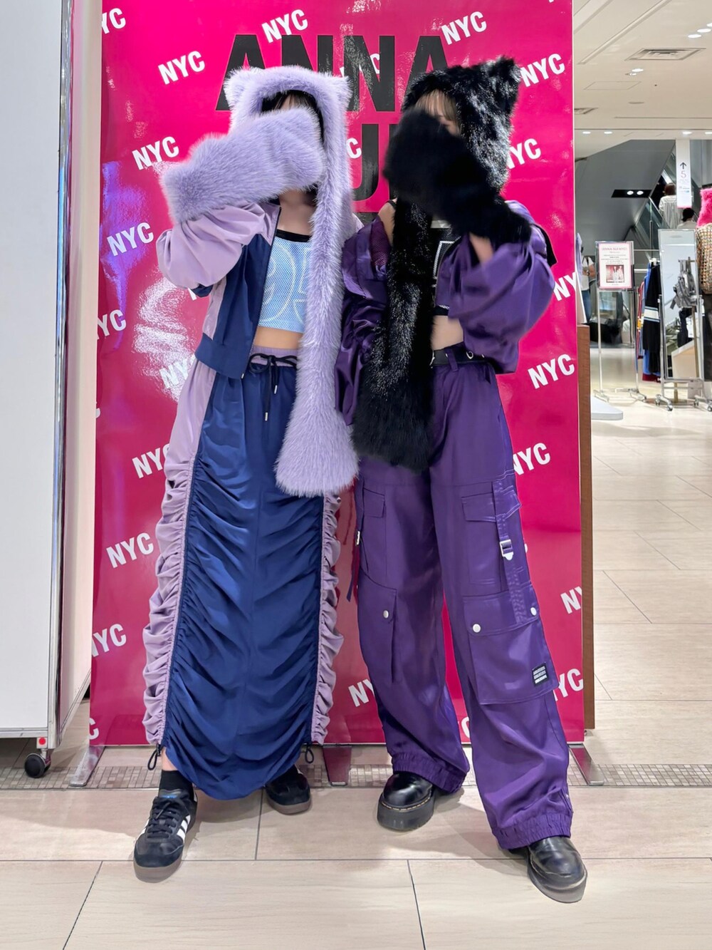 パープル系のスカート、ブルー系のタンクトップ、パープル系のカーゴパンツを着用したレディースの秋コーディネートの2枚目の写真