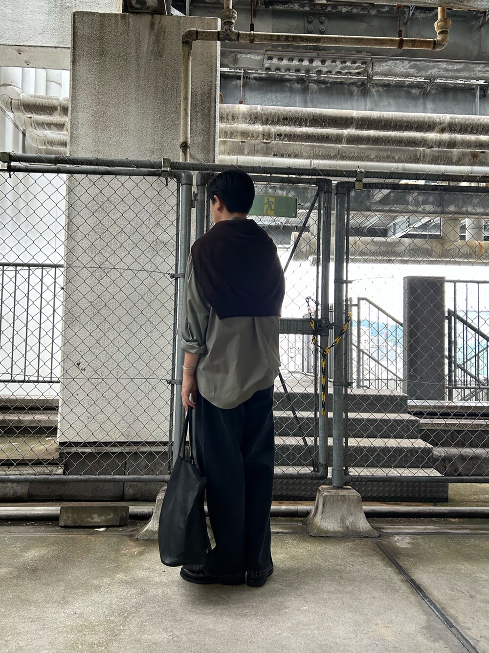 グリーン系のシャツ/ブラウス、ブラウン系のニット/セーター、ブラック系のデニムパンツを着用したメンズの秋コーディネートの3枚目の写真