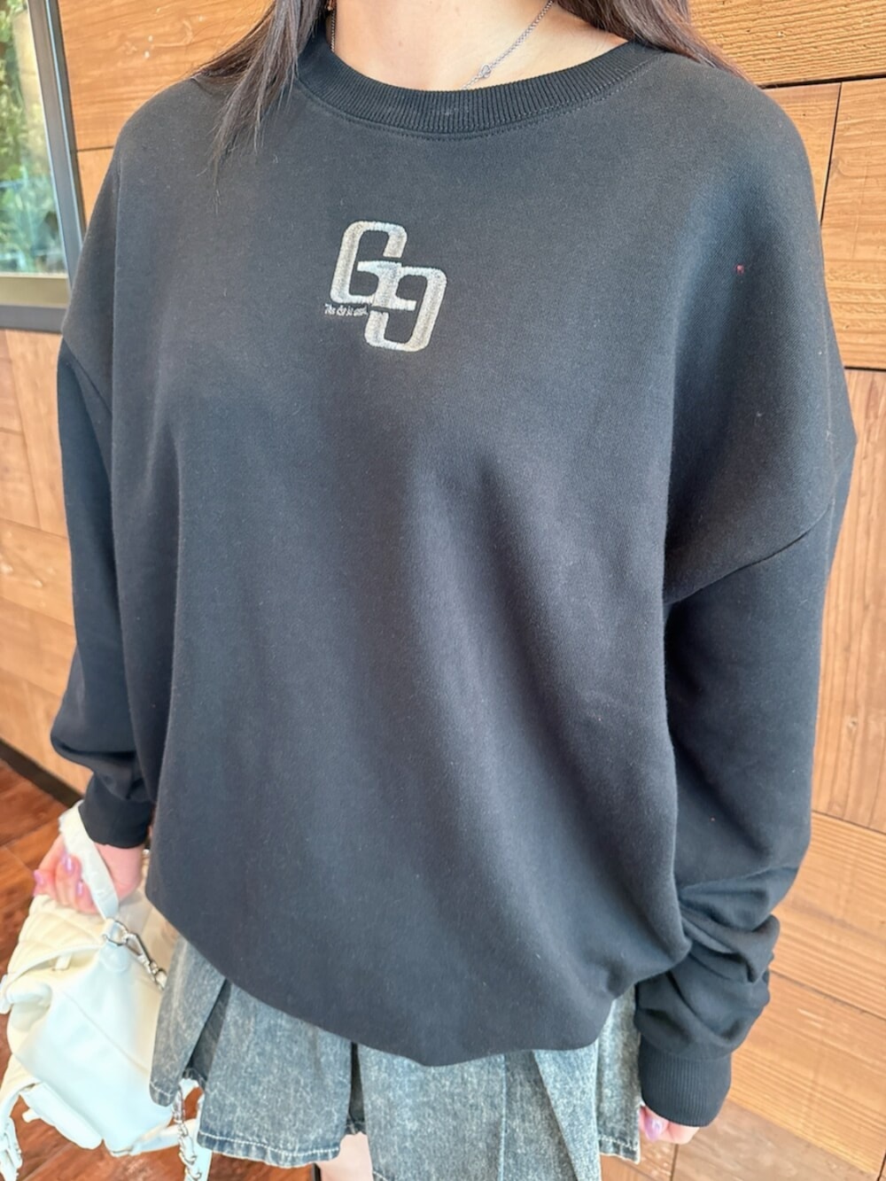 ブルー系のデニムスカート、ブラック系のブーツ、ブラック系のパーカーを着用したレディースの秋コーディネートの7枚目の写真