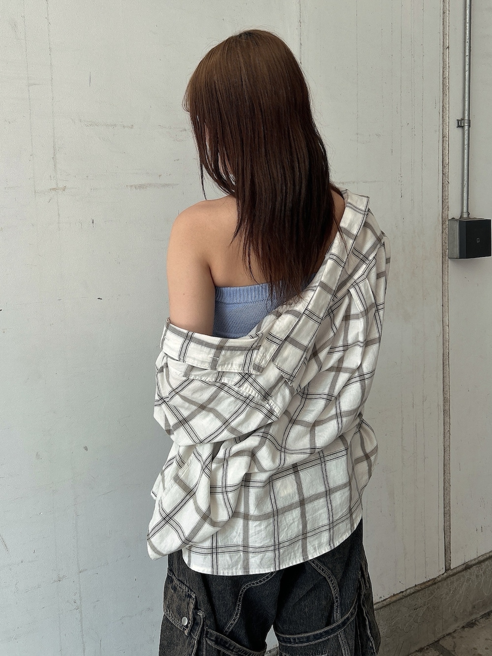 ブルー系のニット/セーター、ホワイト系のシャツ/ブラウス、ブルー系のデニムパンツを着用したレディースの夏コーディネートの6枚目の写真