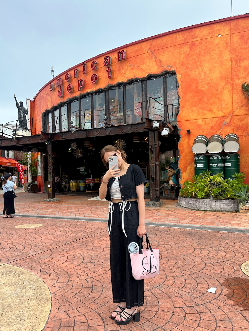 ブラック系のセットアップ、ブラック系のサンダルを着用したレディースの夏コーディネートの2枚目の写真