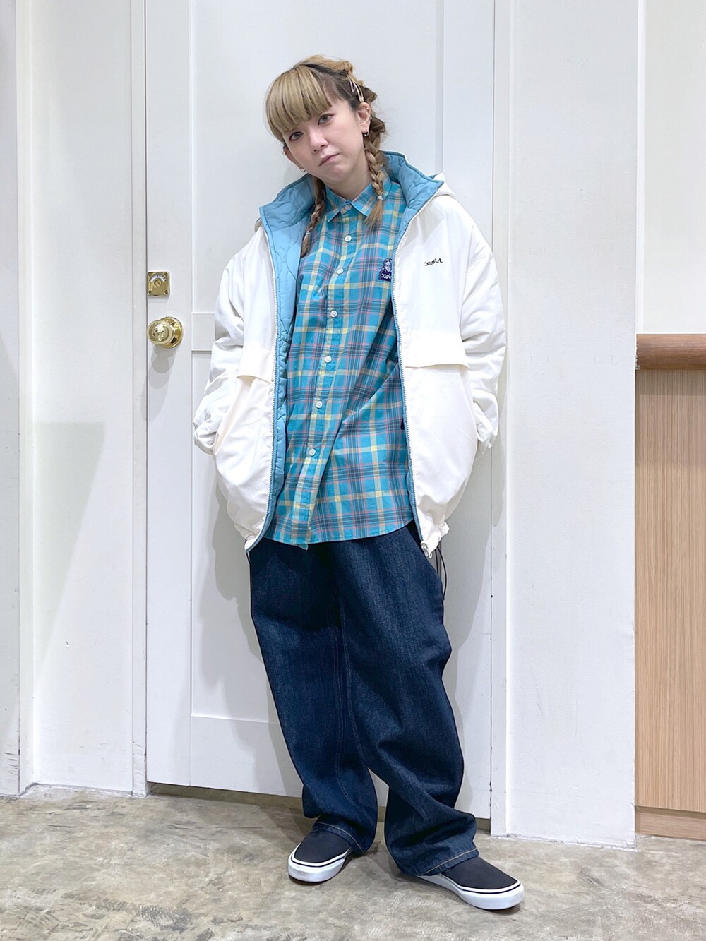 ホワイト系のナイロンジャケット、ブルー系のシャツ/ブラウス、ブルー系のデニムパンツを着用したレディースの秋コーディネートの2枚目の写真