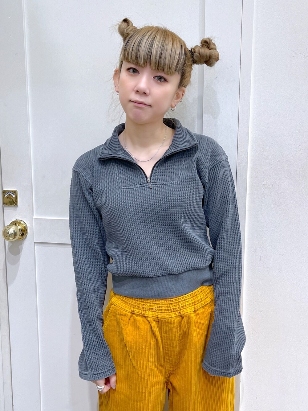 ブラック系のブルゾン、グレー系のTシャツ/カットソー、イエロー系のその他パンツを着用したレディースの冬コーディネートの3枚目の写真