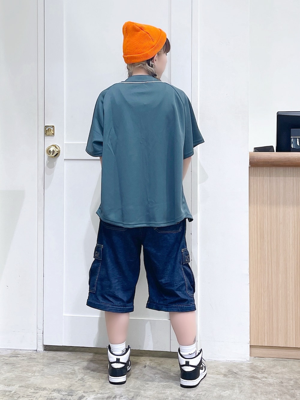 グリーン系のシャツ/ブラウス、ブルー系のデニムパンツ、オレンジ系のニットキャップ/ビーニーを着用したレディースの夏コーディネートの4枚目の写真