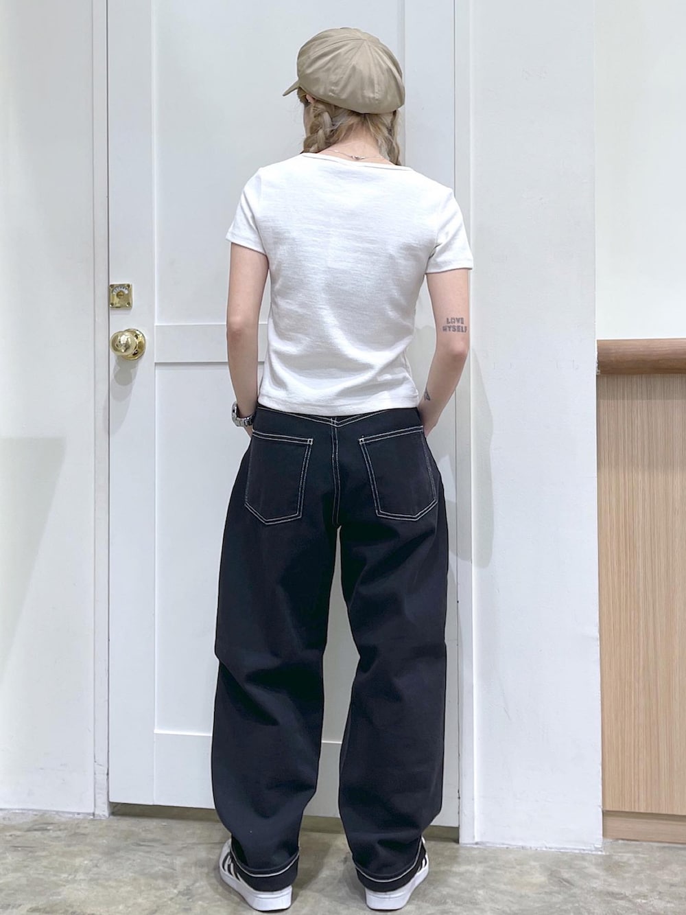 ホワイト系のTシャツ/カットソー、ブラック系のデニムパンツ、ベージュ系のキャスケットを着用したレディースの夏コーディネートの5枚目の写真