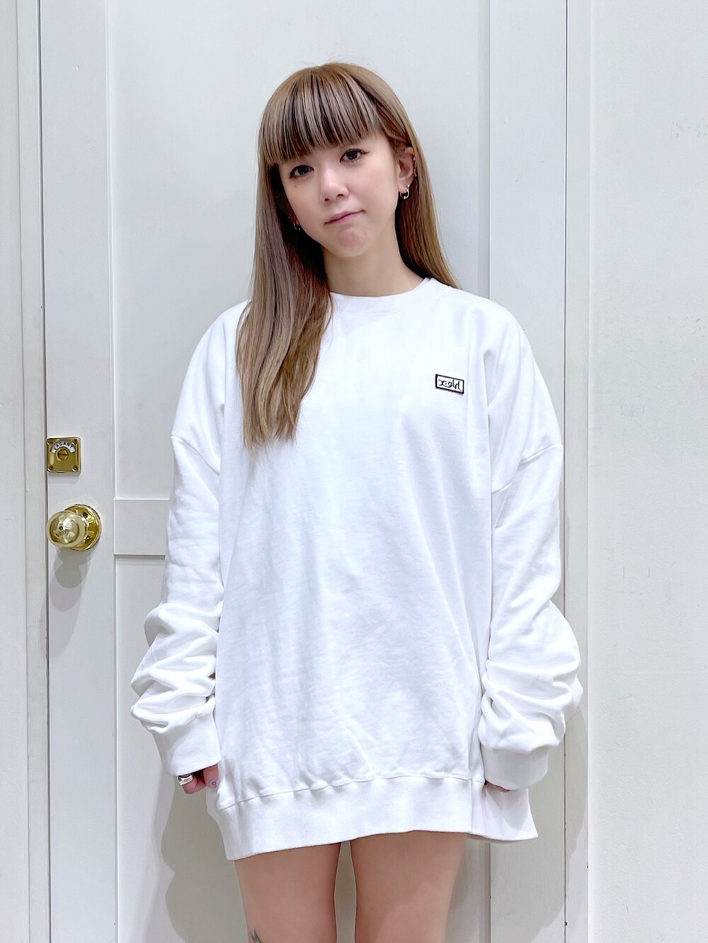 ブラウン系のカーディガン/ボレロ、ホワイト系のスウェット、レッド系のボストンバッグを着用したレディースの冬コーディネートの4枚目の写真