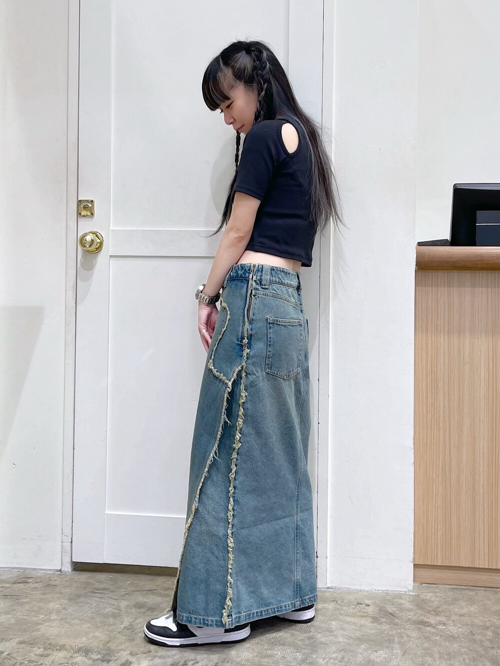 ブラック系のTシャツ/カットソー、ピンク系のショルダーバッグ、ブルー系のデニムスカートを着用したレディースの夏コーディネートの3枚目の写真