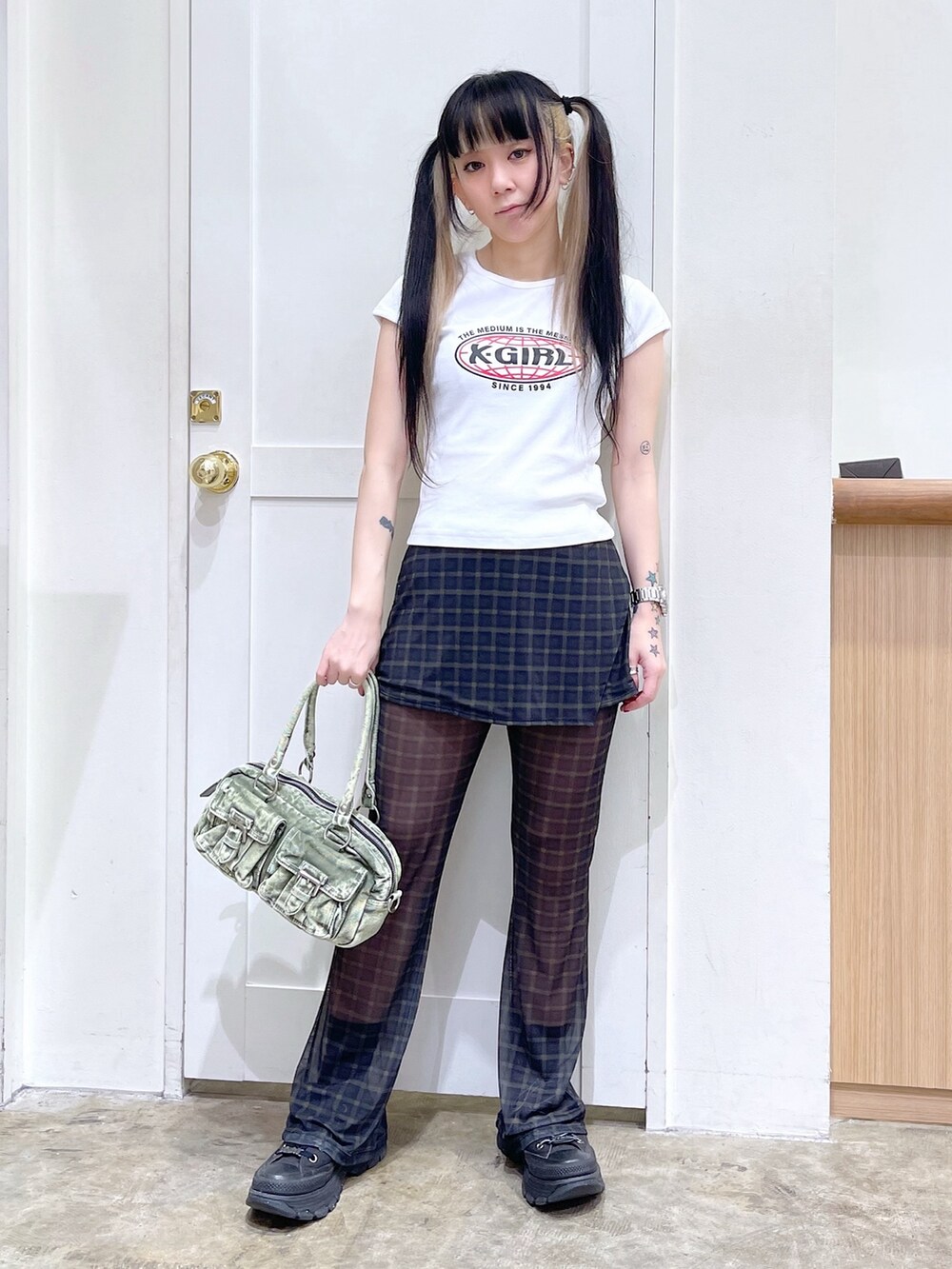 ホワイト系のTシャツ/カットソー、グリーン系のその他パンツ、グリーン系のハンドバッグを着用したレディースの春コーディネートの3枚目の写真