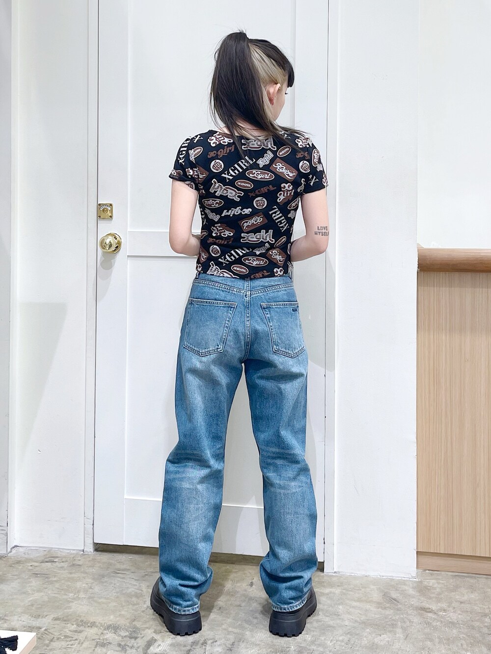 ブラック系のTシャツ/カットソー、ブルー系のデニムパンツ、シルバー系のチョーカーを着用したレディースの春コーディネートの4枚目の写真