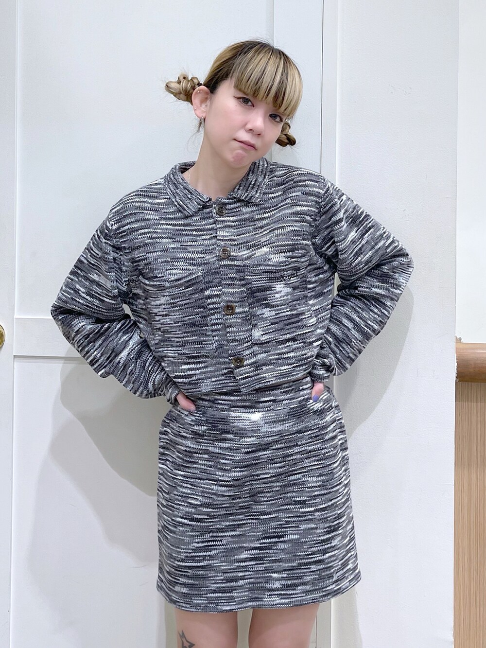 ブラック系のニット/セーター、グリーン系のショルダーバッグ、ブラック系のスカートを着用したレディースの冬コーディネートの4枚目の写真