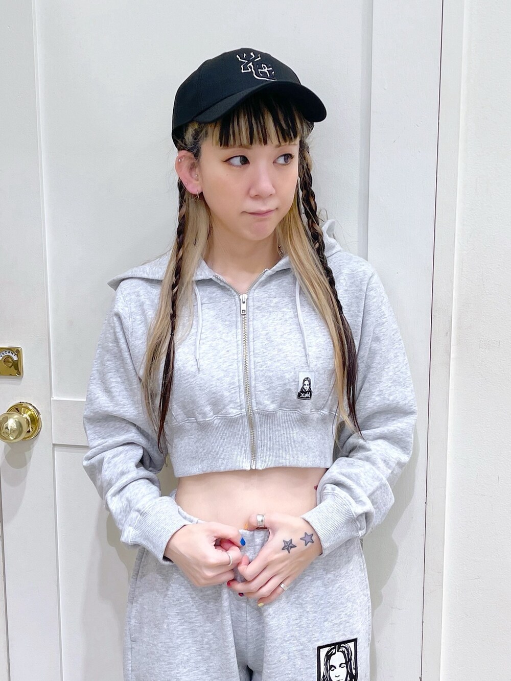 グレー系のパーカー、グレー系のスウェットパンツ、ブラック系のキャップを着用したレディースの春コーディネートの4枚目の写真