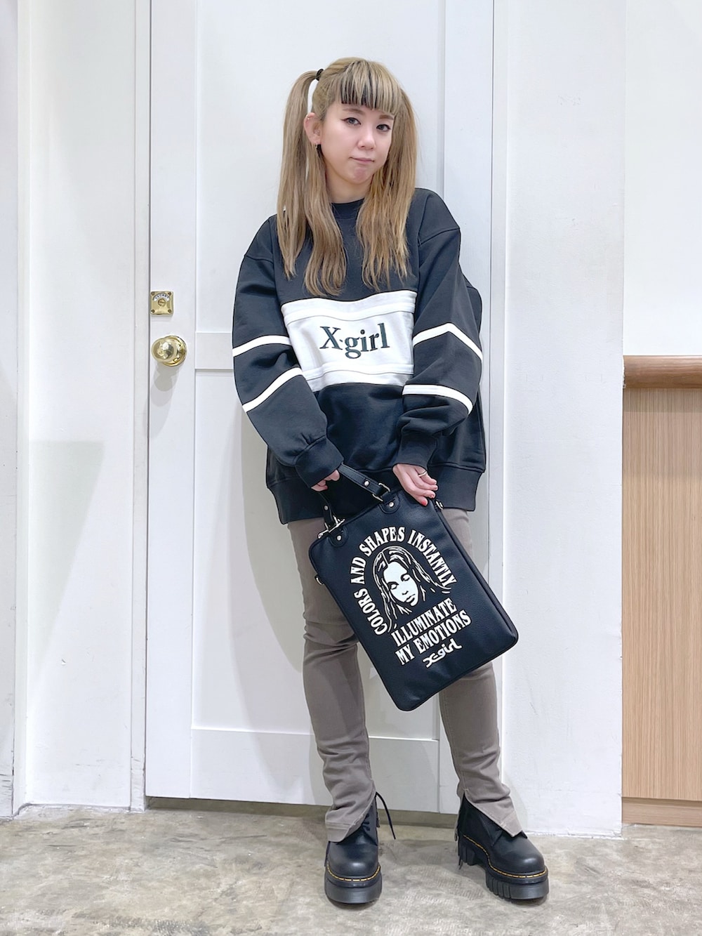 グレー系のスウェット、ブラック系のショルダーバッグ、ベージュ系のその他パンツを着用したレディースの冬コーディネートの2枚目の写真