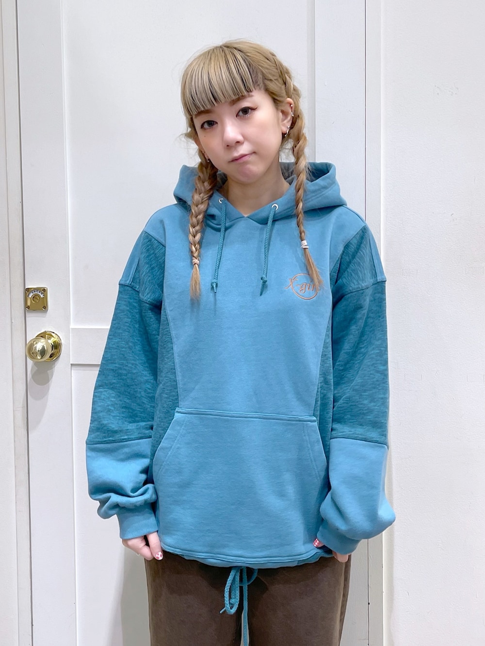 グリーン系のパーカー、ブラウン系のデニムパンツ、グレー系のバックパック/リュックを着用したレディースの冬コーディネートの4枚目の写真