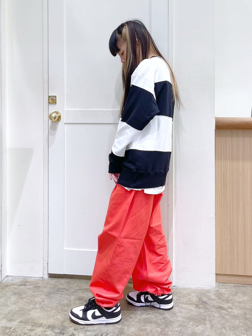 グレー系のその他アウター、ホワイト系のスウェット、オレンジ系のパンツを着用したレディースの秋コーディネートの6枚目の写真