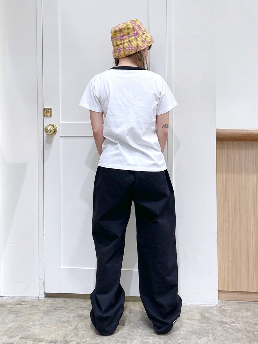 ホワイト系のTシャツ/カットソー、ブラック系のその他パンツ、ホワイト系のスニーカーを着用したレディースの春コーディネートの3枚目の写真