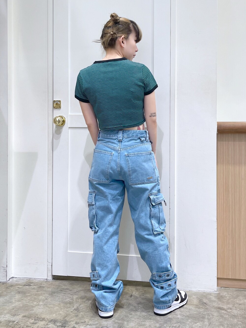 グリーン系のTシャツ/カットソー、ブルー系のカーゴパンツ、ホワイト系のバックパック/リュックを着用したレディースの春コーディネートの4枚目の写真