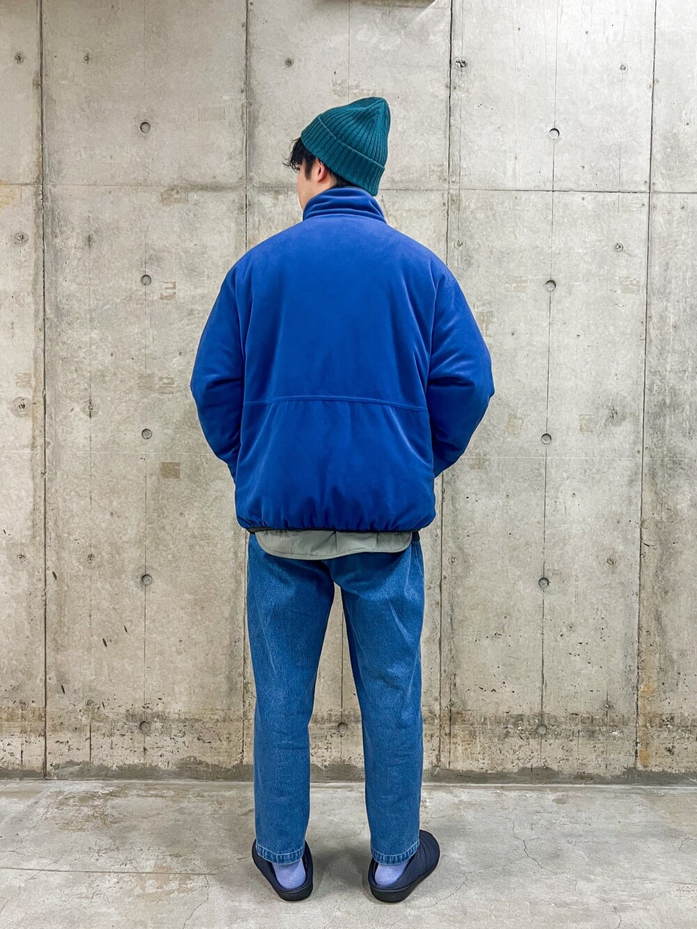 グリーン系のブルゾン、ブルー系のその他パンツ、ブルー系のサンダルを着用したメンズの冬コーディネートの4枚目の写真