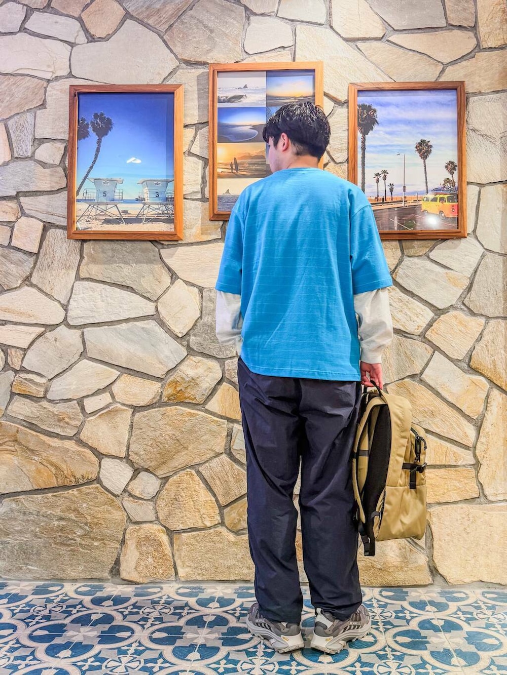 ブルー系のその他パンツ、グレー系のTシャツ/カットソー、グリーン系のバックパック/リュックを着用したメンズの春コーディネートの2枚目の写真