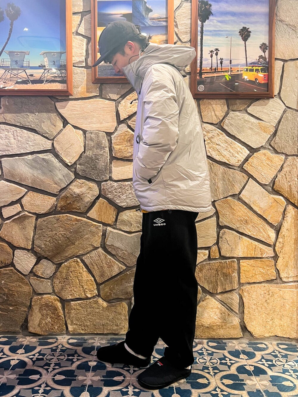 グレー系のダウンジャケット/コート、イエロー系のTシャツ/カットソー、ブラック系のその他パンツを着用したメンズの冬コーディネートの2枚目の写真