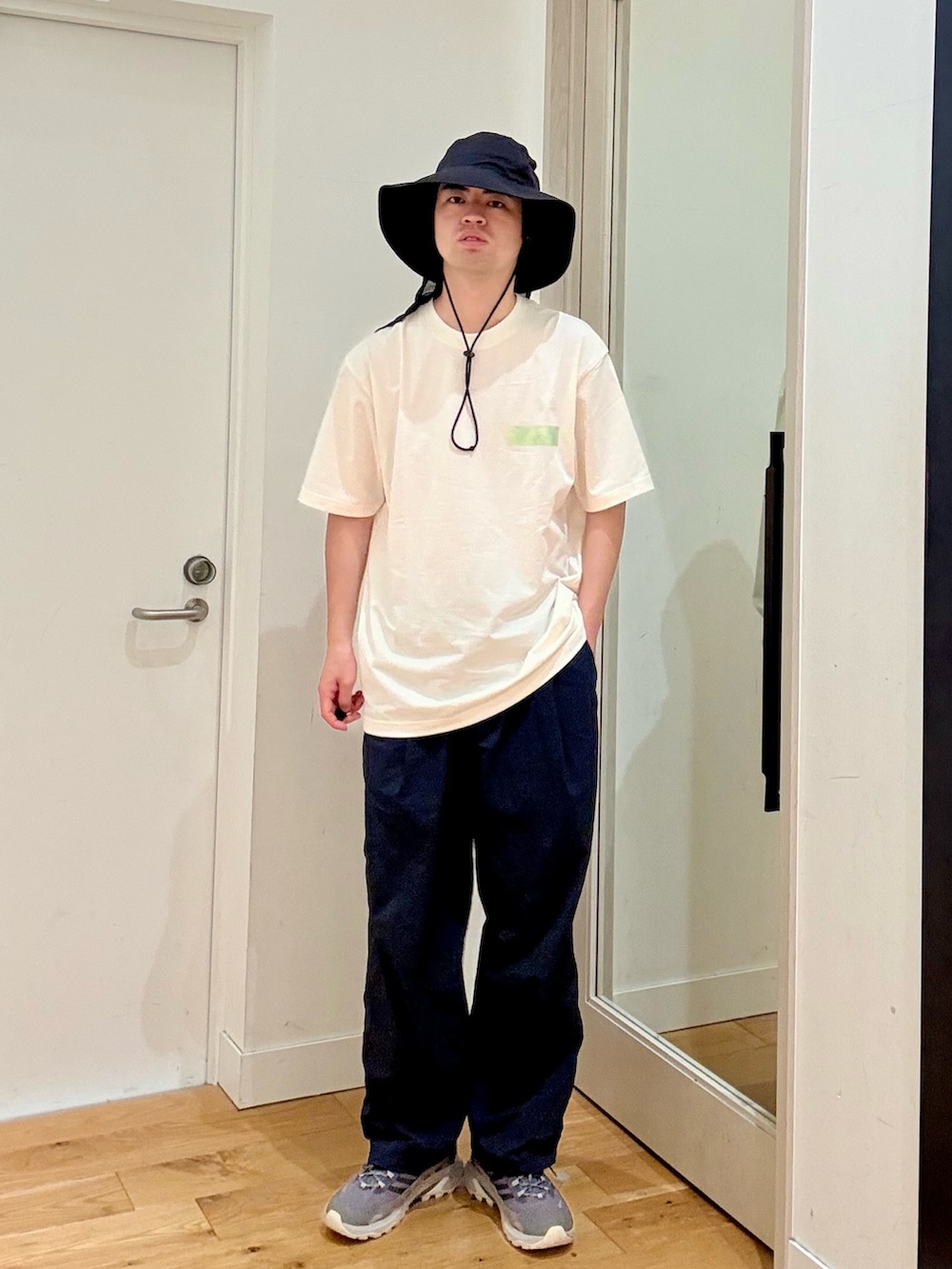 ホワイト系のTシャツ/カットソー、ブルー系のその他パンツ、ブラック系のハットを着用したメンズの夏コーディネートの2枚目の写真