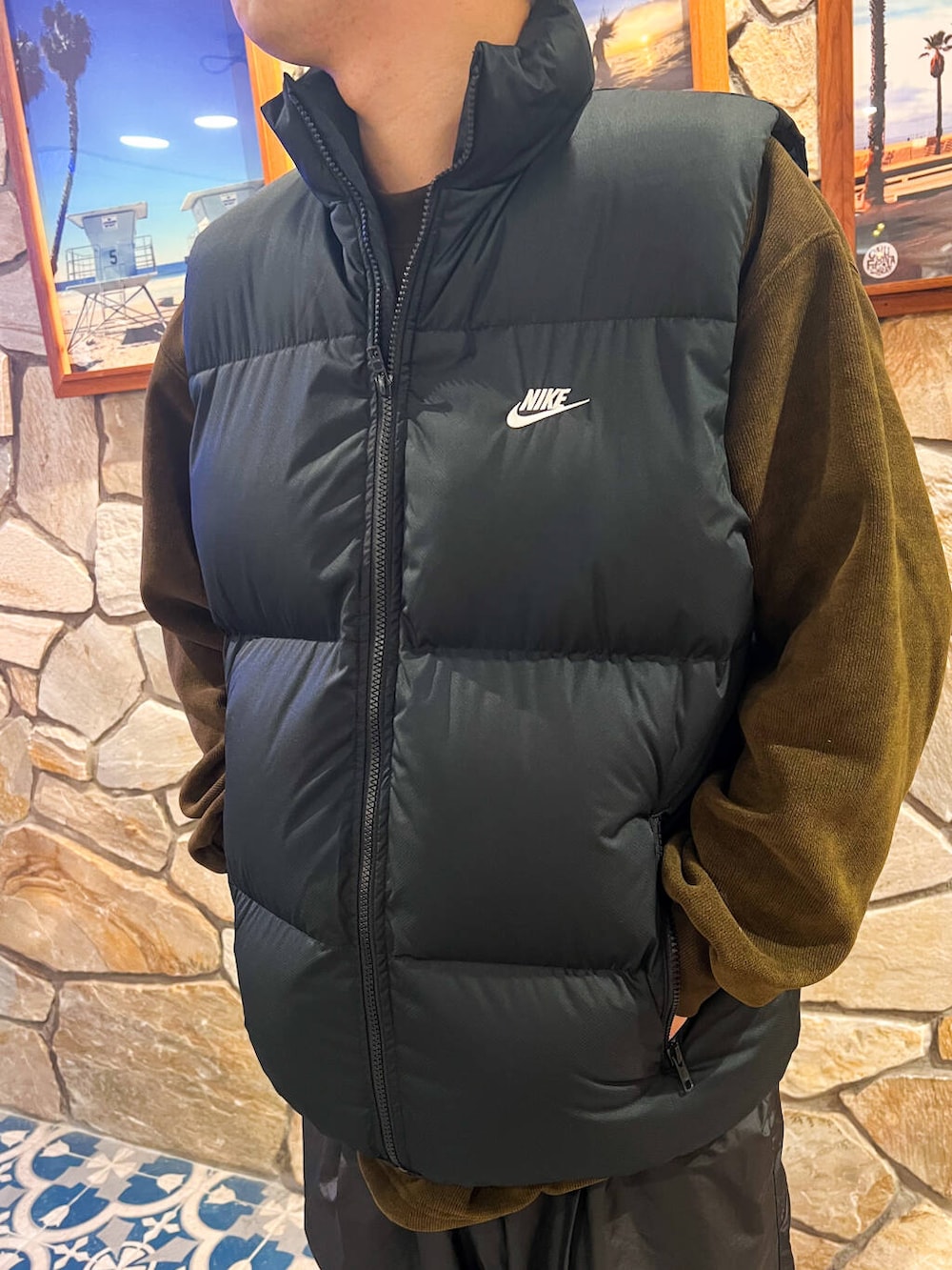 グリーン系のスウェット、ブラック系のダウンベストを着用したメンズの冬コーディネートの3枚目の写真