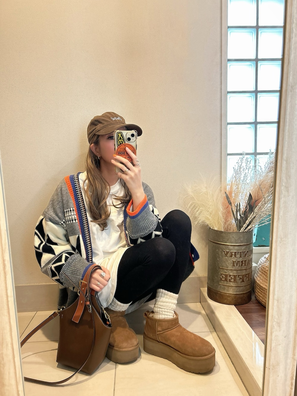 グレー系のカーディガン/ボレロ、ブラウン系のブーツを着用したレディースの春コーディネートの2枚目の写真