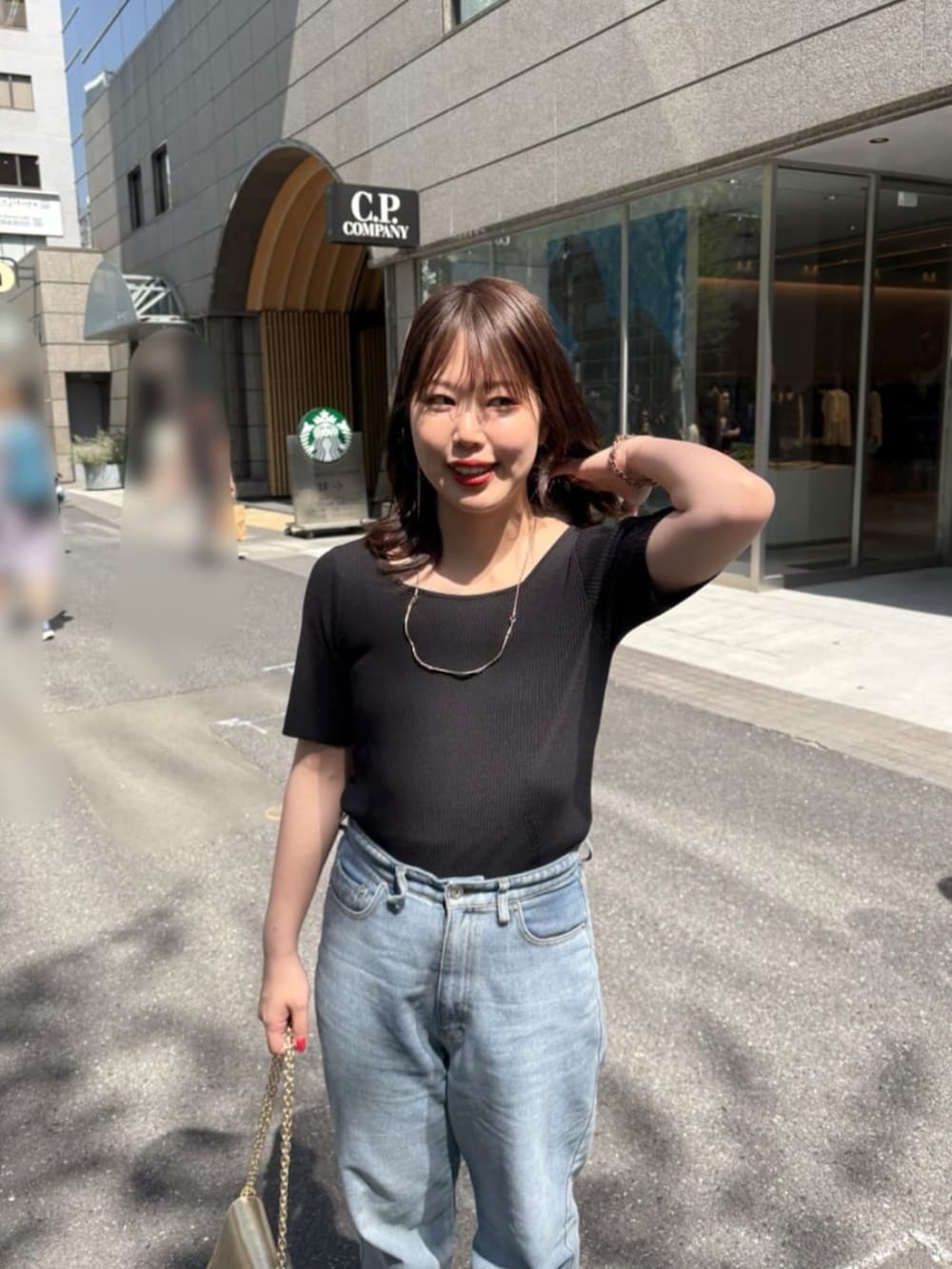 ブルー系のデニムパンツ、ブラック系のニット/セーターを着用したレディースの夏コーディネートの4枚目の写真