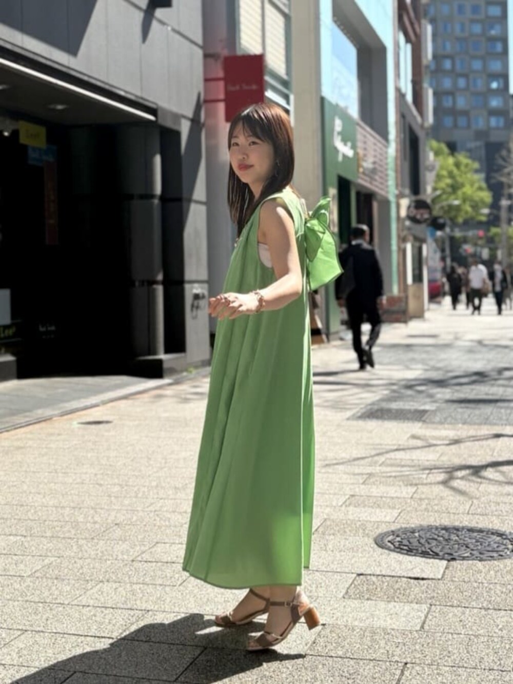 グリーン系のワンピースを着用したレディースの夏コーディネートの4枚目の写真