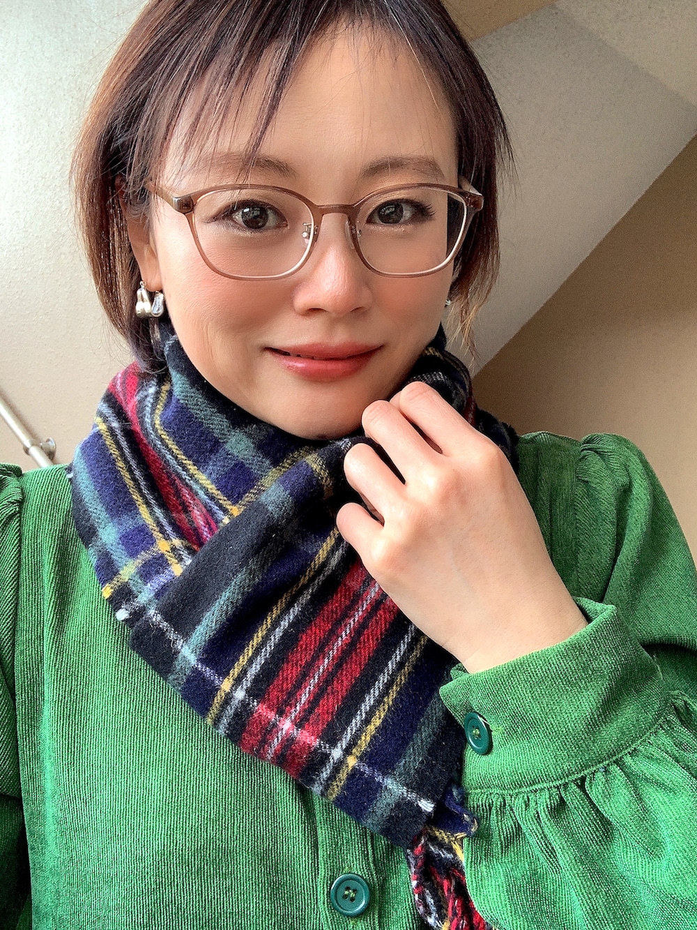 グリーン系のワンピース、ブラック系のブーツ、ブラック系のTシャツ/カットソーを着用したレディースの冬コーディネートの2枚目の写真