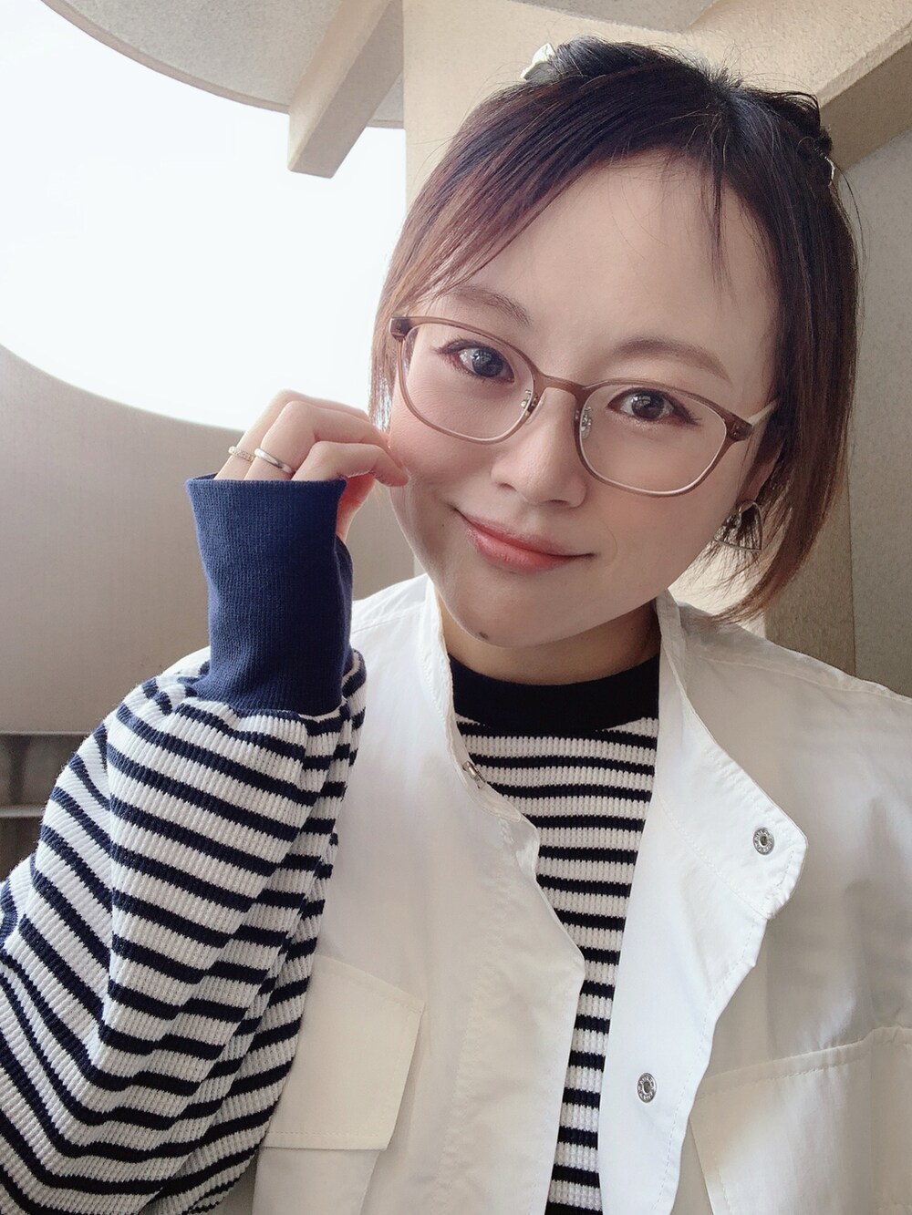 ホワイト系のベスト、ブルー系のTシャツ/カットソー、ブルー系のデニムパンツを着用したレディースの春コーディネートの2枚目の写真