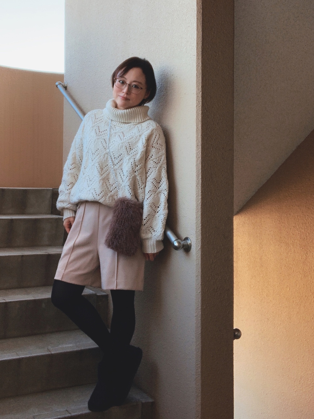 ホワイト系のニット/セーター、ベージュ系のその他パンツ、ベージュ系のキャミソールを着用したレディースの冬コーディネートの3枚目の写真