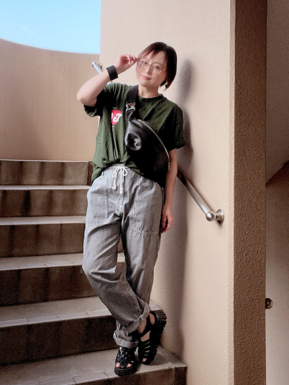 グリーン系のTシャツ/カットソー、ブルー系のその他パンツ、ブラック系のサンダルを着用したレディースの夏コーディネートの3枚目の写真