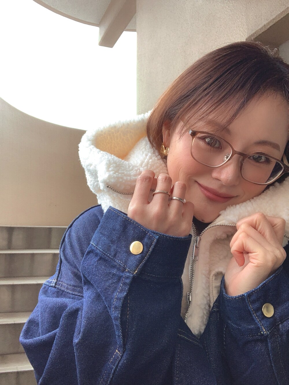 ブルー系のデニムジャケット、グレー系のニット/セーター、ホワイト系のその他パンツを着用したレディースの冬コーディネートの3枚目の写真