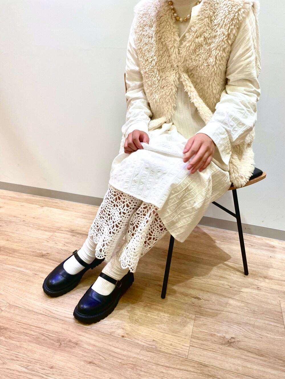 ホワイト系のベスト、グリーン系のバレッタ/ヘアクリップを着用したキッズの秋コーディネートの3枚目の写真