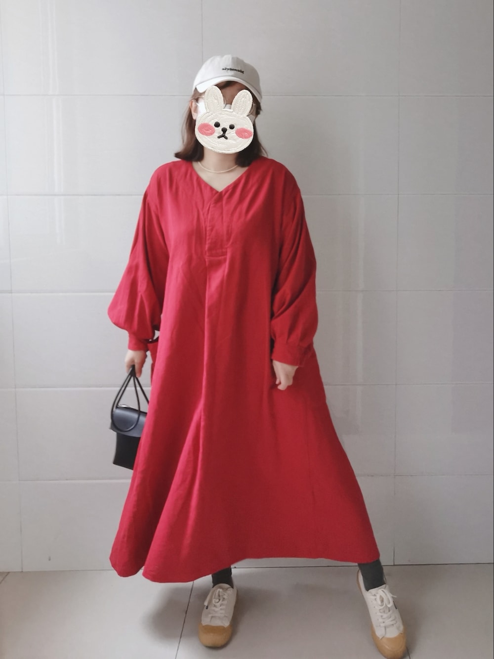 レッド系のワンピース、ブラック系のショルダーバッグを着用したレディースの春コーディネートの4枚目の写真