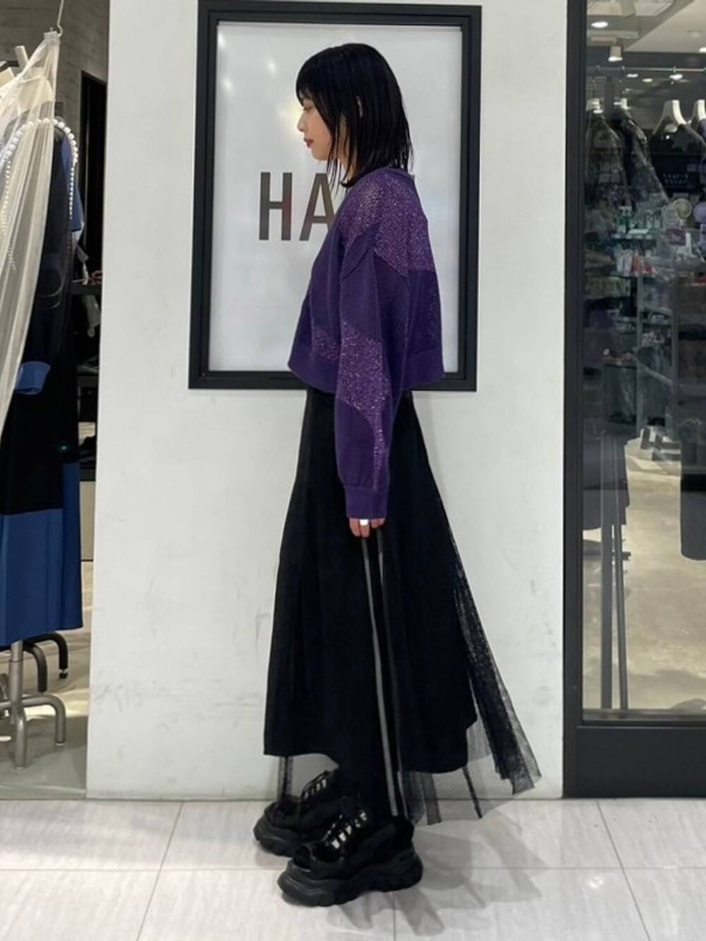 パープル系のカーディガン/ボレロ、ブラック系のショルダーバッグ、ホワイト系のタンクトップを着用したレディースの夏コーディネートの4枚目の写真