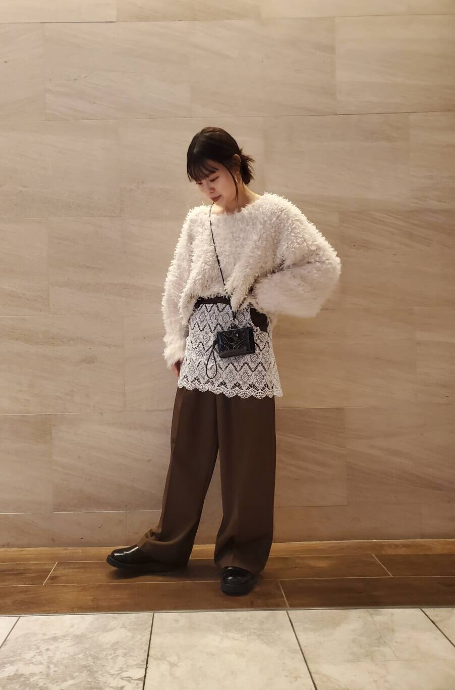 ホワイト系のニット/セーター、ブラウン系のその他パンツを着用したレディースの冬コーディネートの2枚目の写真