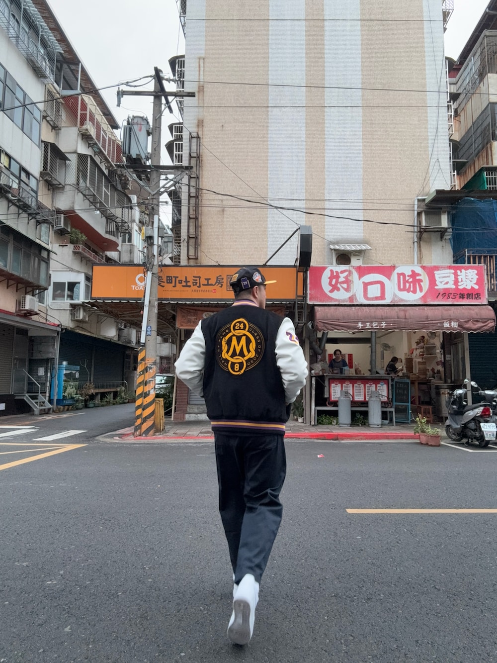 ブラック系のジャージ、ブラック系のスタジャン、グリーン系のチノパンツを着用したメンズの冬コーディネートの2枚目の写真